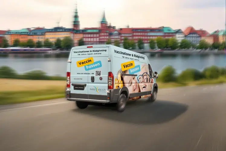 Vaccinbuss på väg i stadsmiljö, erbjuder vaccinationer och rådgivning.